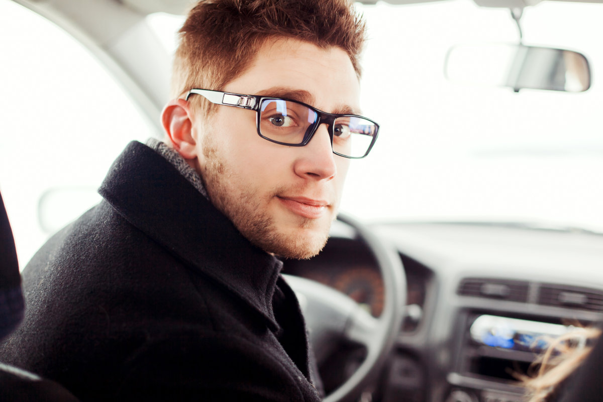 close-up-young-man-with-glasses-sitting-car
